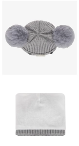 Detail of grey baby knit hat showing soft white cotton lining and cute faux fur pom poms