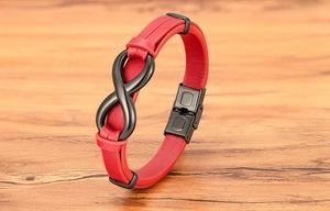 Detail of red leather bracelet with black infinity symbol and stainless steel clasp
