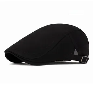 Detail of black cotton flat cap featuring metal side buckle and breathable mesh side panel