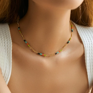 Detail of colorful stone beaded necklace on model showing bohemian chic choker design