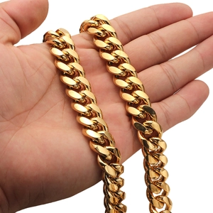 Close-up of gold Cuban link chain showing polished stainless steel and secure clasp