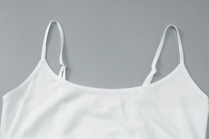 Close-up of white ribbed camisole top with adjustable thin straps and a classic U-neckline