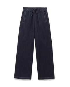 Detail of dark blue denim wide-leg pants with elastic drawstring waist and white stitching