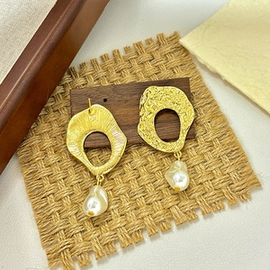 Vintage baroque pearl drop earrings with hammered gold metal texture in a 45-degree view