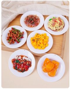 Top view of six realistic miniature food models with white plates on a wooden tray