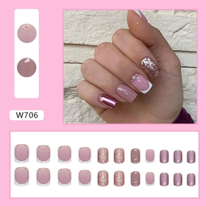 Short white French press-on nails with pearl glitter finish and metallic pink details