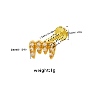 Detail of gold labret stud with zircon teeth design and specific size measurements