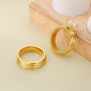 Close-up of 18K gold plated stainless steel ring set with faceted texture and zircon