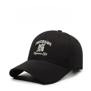 Detail of embroidered marason shield logo and text on a black cotton baseball cap