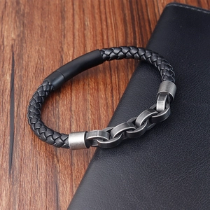 Detail of hand-woven black leather cord and metal chain clasp for men's bracelets