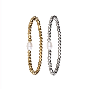 Detailed view of gold and silver beaded bracelets with baroque freshwater pearls
