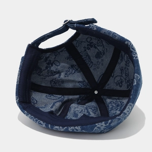 Detail of vintage denim brimless docker cap showing inner lining and metal buckle