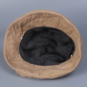 Detailed inner view of khaki cotton sun hat with black lining and sweatband stitching