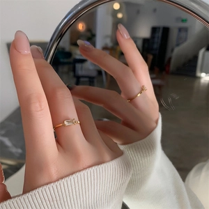 Detailed mirror reflection of an 18K gold-plated ring with a square-cut zirconia stone