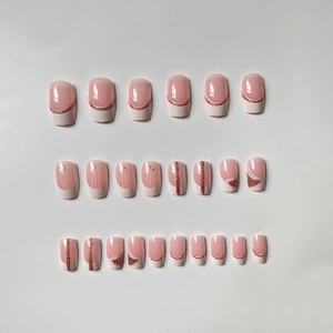 Short French press-on nails in white and rose gold glitter with geometric pattern