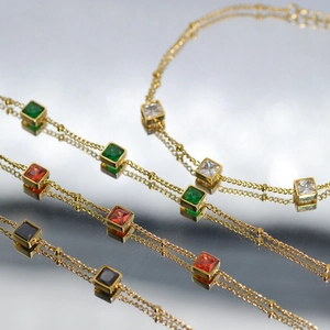 Close-up of square cut multicolored gemstones on 18K gold plated stainless steel rings