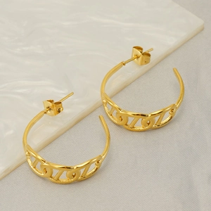 Modern C-shaped gold stainless steel earrings with cutout link design on marble background