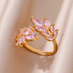 Detailed macro view of gold flower ring featuring pink marquise-cut zircon stones on silk