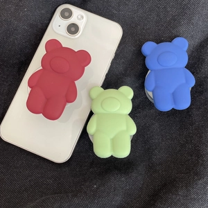 Cute matte 3D bear cell phone grip pop socket in red, blue, and green colors