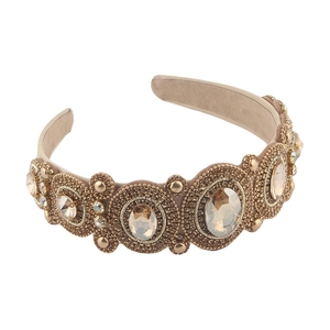 Vintage style headband with sparkling blue crystals and amber gold frame on white background