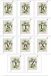 Detail of Christmas garden flags with floral wreaths and black alphabets on faux linen