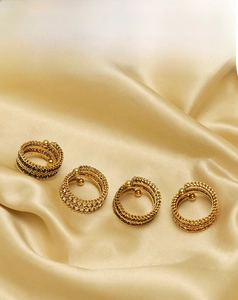 Detail of four 18k gold plated stainless steel rings with colorful micro-inlaid stones