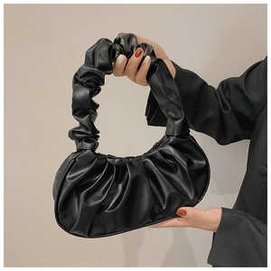 Detailed view of the soft black pleated cloud bag with elegant ruched handle design
