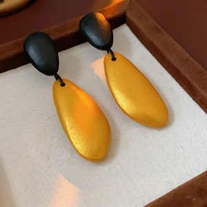Irregular drop wood bead earrings with matte gold finish in a luxury wood jewelry box
