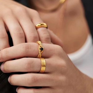 Detailed view of three gold rings featuring smooth, twisted rope, and striped textures