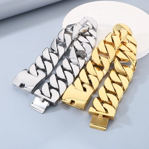 Detail of 43mm oversized chunky Cuban chain necklaces in gold and steel finishes