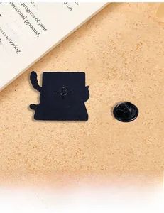 Detailed macro view of black enamel pin back with anti-slip texture and rubber clasp
