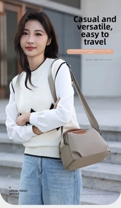 Outdoor shot of a khaki waterproof Oxford fabric crossbody bag with wide shoulder strap