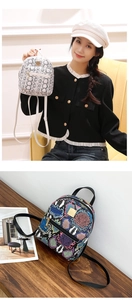 Close-up of stylish mini faux snakeskin backpacks with gold zippers and hardware