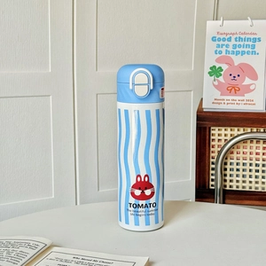 Detail of blue striped insulated bottle with cute rabbit icon and secure safety lock