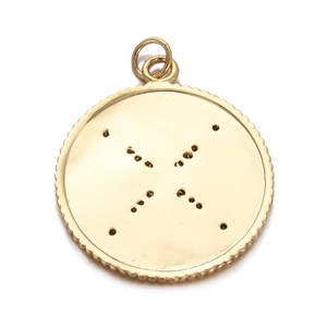 Close-up of golden round compass pendant with celestial patterns and textured edges