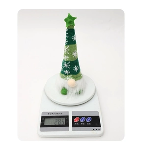 Lightweight knitted Christmas gnome plush weighs 28.5g on a scale for festive decor