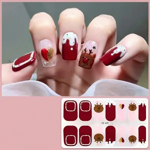Detail of Christmas nail stickers with reindeer, heart, and snowflake embossed patterns