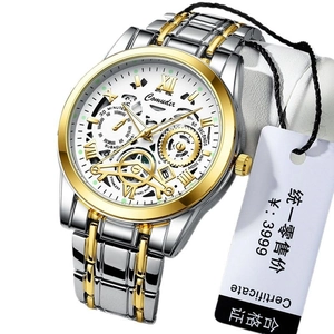 Men's skeleton mechanical watch with silver and gold stainless steel strap on a stand