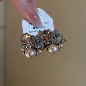 Elegant floral pearl earrings with champagne crystals and silver rose details