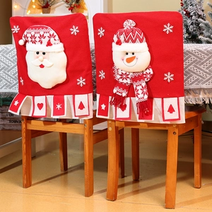 Detail of 3D Santa and snowman plush characters on red knitted Christmas chair covers