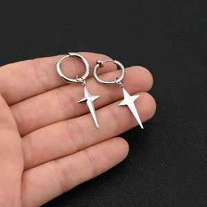Minimalist silver stainless steel hoop earrings with 3D star charms held in hand