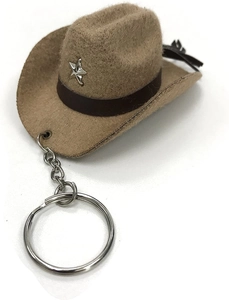 Detail of a mini khaki felt cowboy hat keychain featuring a silver star rivet and leather band