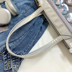 Silver Ita bag tote featuring a transparent display window and layered zipper pockets