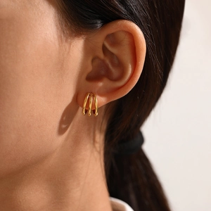 Minimalist gold-plated stainless steel triple hoop C-shaped earrings on model ear