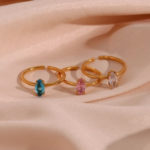 Detailed close-up of three 18K gold-plated open rings with marquise zircon stones