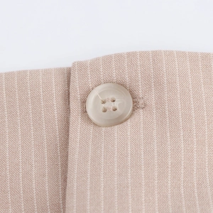 Preppy style beige pinstripe mini dress featuring a transparent four-hole button detail