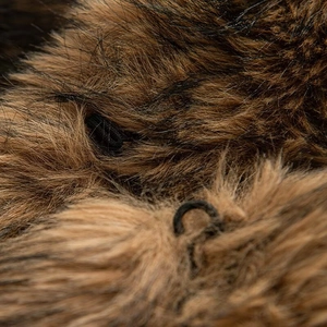 Macro view of luxurious faux fur texture in brown and black with elastic buckle detail