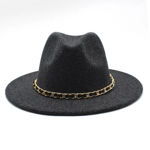 Detailed macro view of black wool felt fedora featuring a gold chain trim decoration