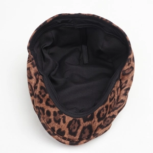 Detailed interior of leopard print beret showing black lining and adjustable strap