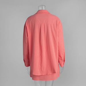 Back detail of coral pink cotton shirt showing pleat and textured breathable fabric